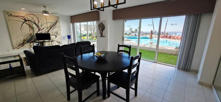 Living room of a 1-bedroom condo with a view of the pool