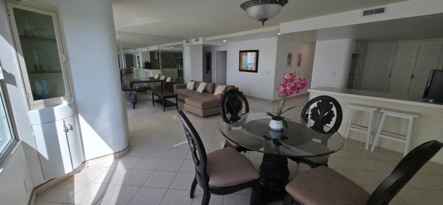 Open living and dining area of a 2-bedroom condo